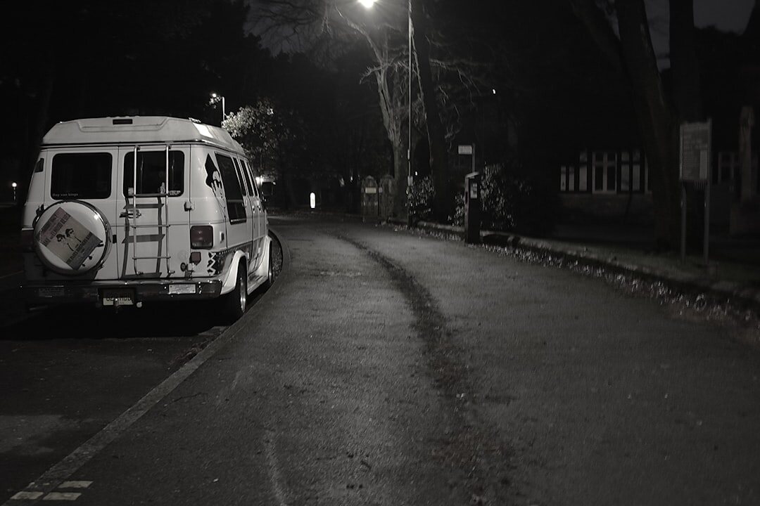 Outside broadcast van with satellite dish parked near a city street